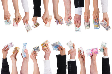 a lot of hands with important currencies isolated on whiteの写真素材