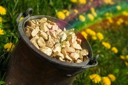 Pot of gold with rainbow in a meadowの写真素材