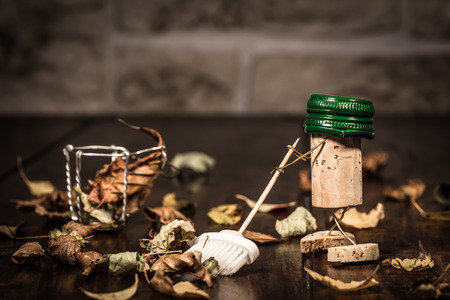 Concept sweep leaves with a broom, wine cork figures