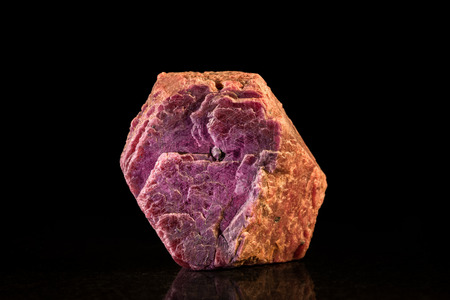 rough ruby mineral stone in front of Blackの写真素材