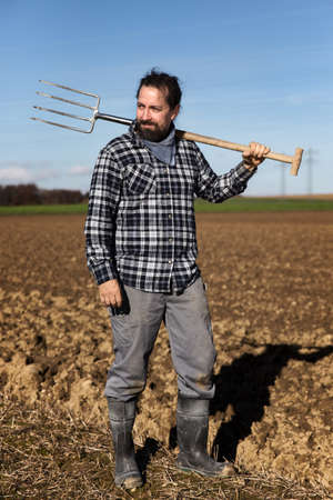 a Portrait of a european Farmer with a pitchforkの写真素材