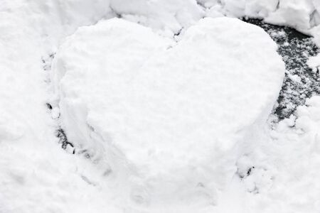 a heart shape drawn in the snowの写真素材