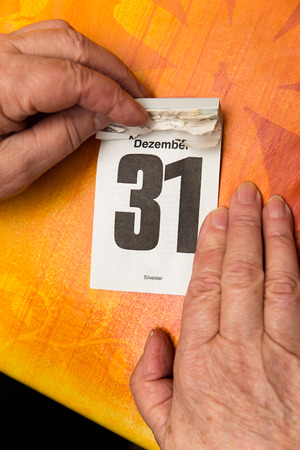 female senior adults hands with calendar 31 Decemberの写真素材