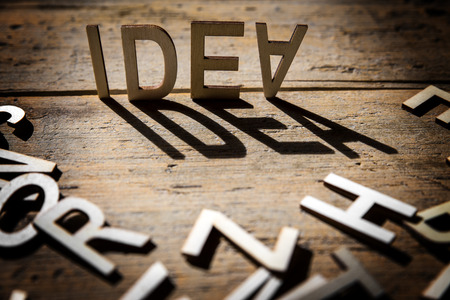 wooden letters on old aged wooden table build the shadow word idea, vintage styleの写真素材