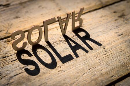 wooden letters on old aged wooden table build the shadow word solar, vintage styleの写真素材