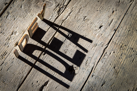 wooden letters on old aged wooden table build the shadow word idea, vintage style