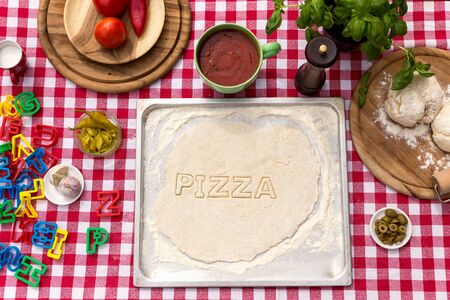 cut out letters, dough on a griddle, red white tableclothの写真素材