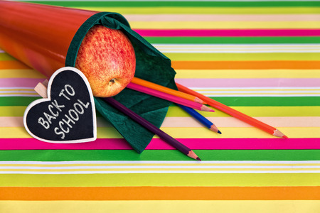 orange school bag with text back to school, lot of colorful crayonsの写真素材