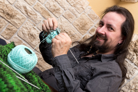 do it yourself man is knitting a wool hat
