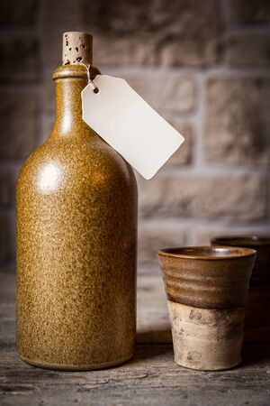 old retro potteries with a empty note on the bottleの写真素材