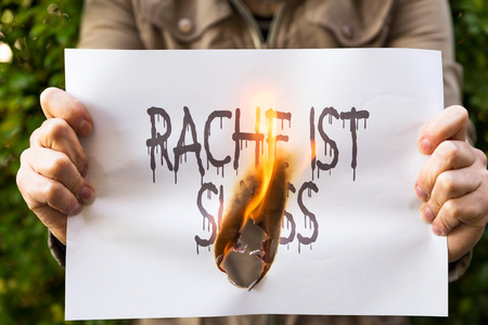 Woman is holding burning paper, with the german sentence Rache ist suess, means sweet revengeの写真素材