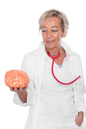 female doctor is holding an plastic brain, isolated in front of whiteの写真素材