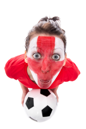 female english painted soccer fan with ball is looking surprised, isolated on whiteの写真素材