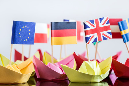 paper ships with different flags are building a fleetの写真素材