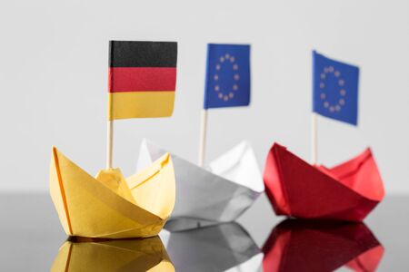 paper ship with german and european flag, concept shipment or free trade agreement and membership of euの写真素材