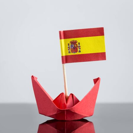 paper ship with spanish flag, concept shipment or free trade agreementの写真素材
