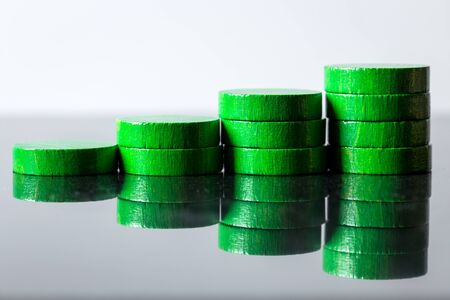 different stacks of green wooden slices, concept finance and businessの写真素材