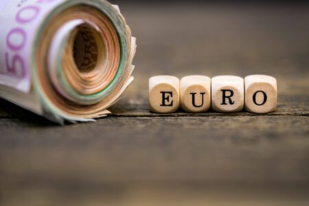 wooden squares with the inscription euro, money roleの写真素材