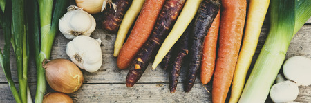 panorama of organic and raw vegetables on a wooden  table