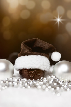 christmas balls, pointed hat and pearls, festive sparkling background with starsの写真素材