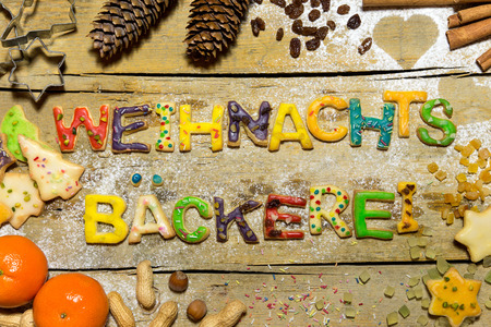 Cookie letters with christmas decoration on wood, german text weihnachtsbaeckerei, which means christmas bakeryの写真素材