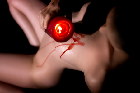 nude woman with a candle, hot wax on the skin, bdsm, sm and loveplay, waxingの写真素材