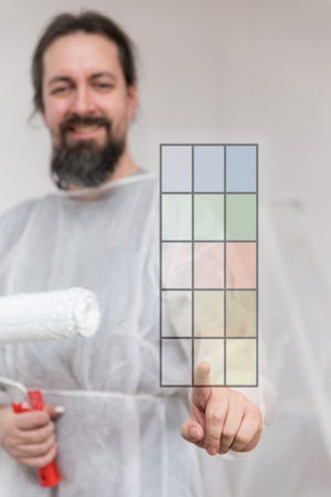 man with painter roller, concept of home improvement, colour decisionの写真素材