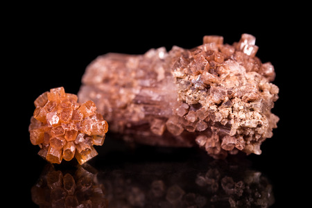 two Aragonite gemstone, black background with reflections, mineral and healing stoneの写真素材