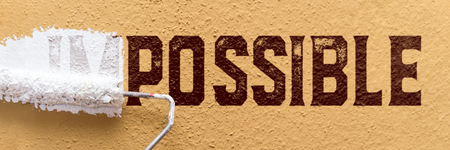 Impossible turns to possible, business concept with a paint roller at the wall, bannerの写真素材
