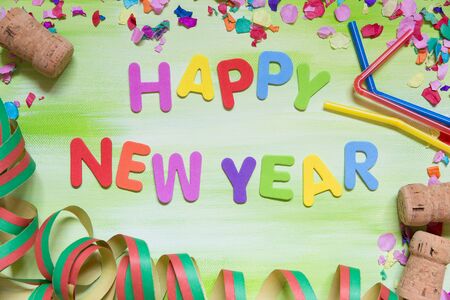 colorful letters with corks, confetti and straws, text happy new yearの写真素材