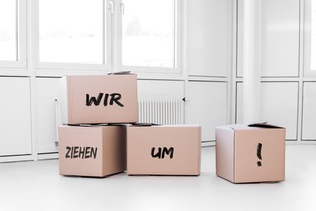 white room with cartons and the german words wir ziehen um which means we are moving