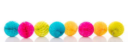 lot of colorful lampions in a row, isolated in front of white backgroundの写真素材