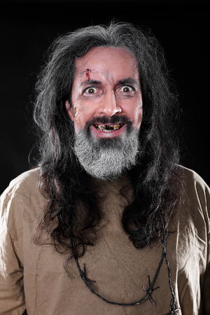 toothless and insane man in front of black backgroundの写真素材