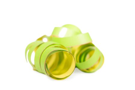one green curled streamer, isolated on white backgroundの写真素材