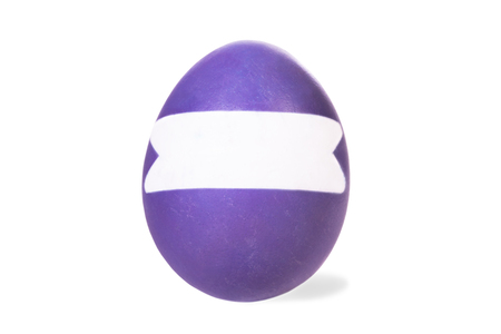 one purple colored easter egg and white stripe with copyspace, isolated on whiteの写真素材