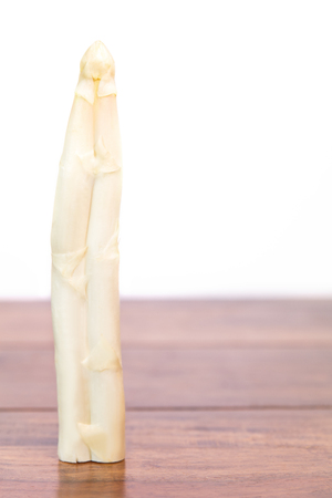 Two asparagus are one, adnate and rustic vegetable, white backgroundの写真素材