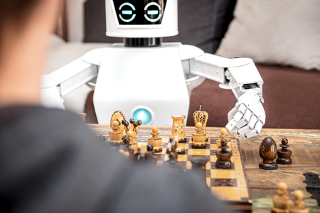 autonomous cyborg or roboter is playing chess, concept strategy or adaptive ki with chess computerの写真素材