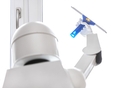 a autonomous robot is washing a window with a tool, using his robot hand for the routine jobの写真素材