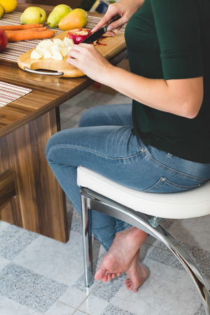 young woman cutting fruits, concept diet and health, fruit saladの写真素材