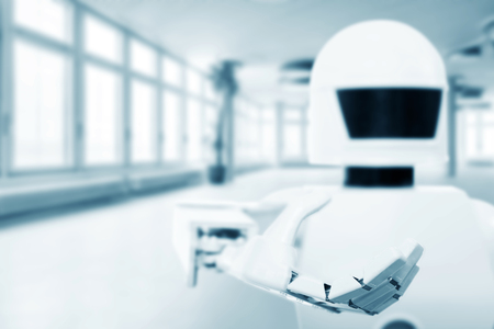 autonomous service robot in front of an empty room, with lot of copyspace, concept future technology backgroundの写真素材