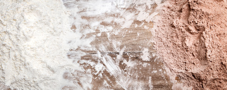 Two bakery mixtures, white and brown with cocoa powder, panorama with copyspaceの写真素材