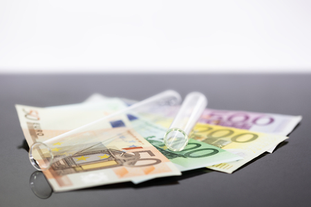 Concept image panoramic test tube with euro banknotes, concepts such as research fees or tuition, expensive medicine or pharmaceutical industryの写真素材