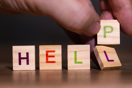 Hand exchanges the letter L from the word bright for a P, giving the word helpの写真素材