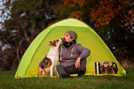 Camping with the pet, friendship between man and his cute dogの写真素材
