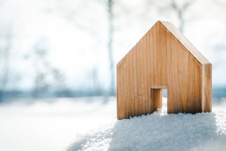 Small wooden House standing in the snow, planning Housebuilding on the building area, copyspaceの写真素材