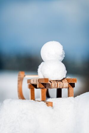 Snowballs on a little wooden sledge, concept winter and snow, copyspaceの写真素材