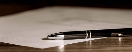 Banner, pen and paper on wooden table, concept contract, submission or last will, copyspaceの写真素材