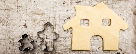 Cookie cutters and raw dough, concept family and homestead, house and child, panoramaの写真素材