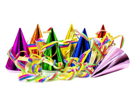 Colorful party hats and paper streamers isolated on white background, invitation for birthday or carnivalの写真素材