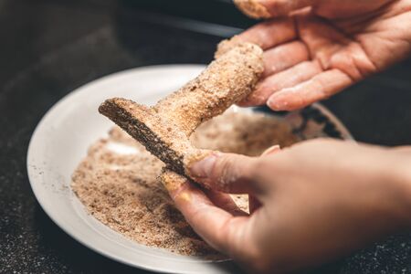 Breaded king oyster mushroom, cooking a delicious gourmet meal, female handsの写真素材